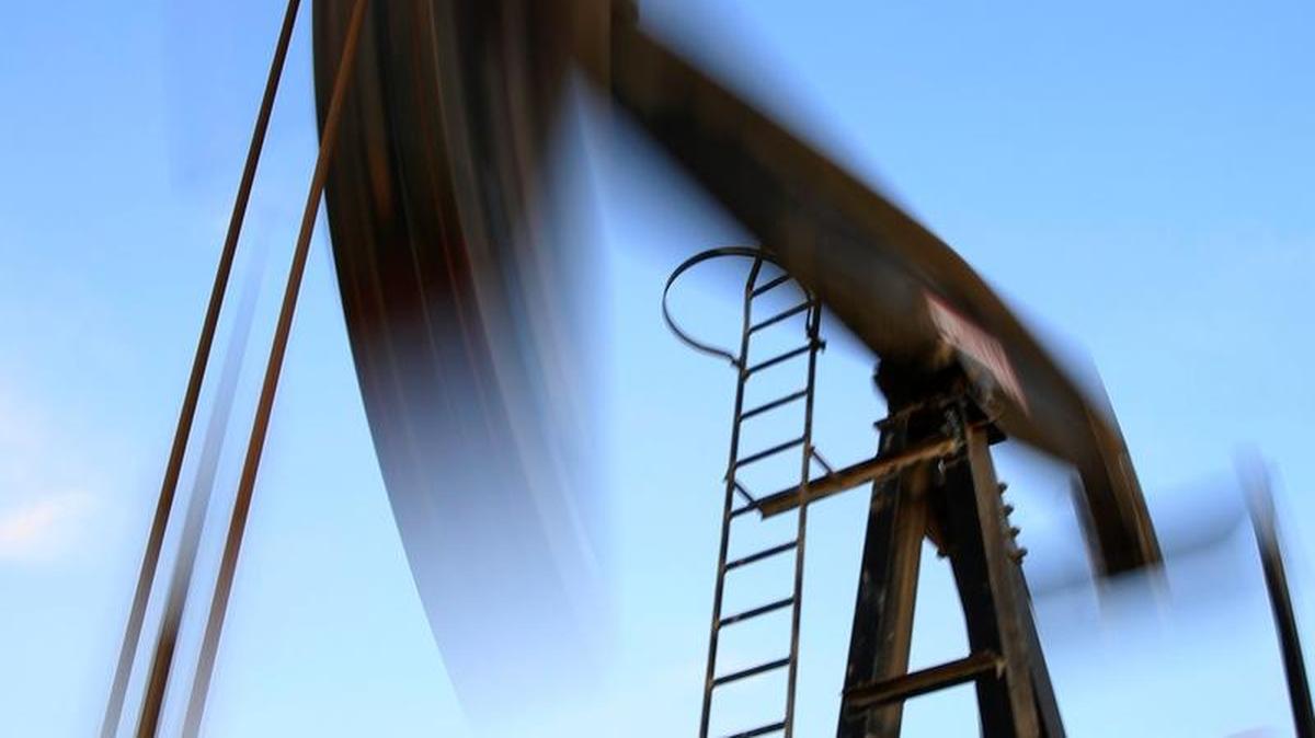 An oil pump works at sunset Monday, Dec.7, 2015, in the desert oil fields of Sakhir, Bahrain.