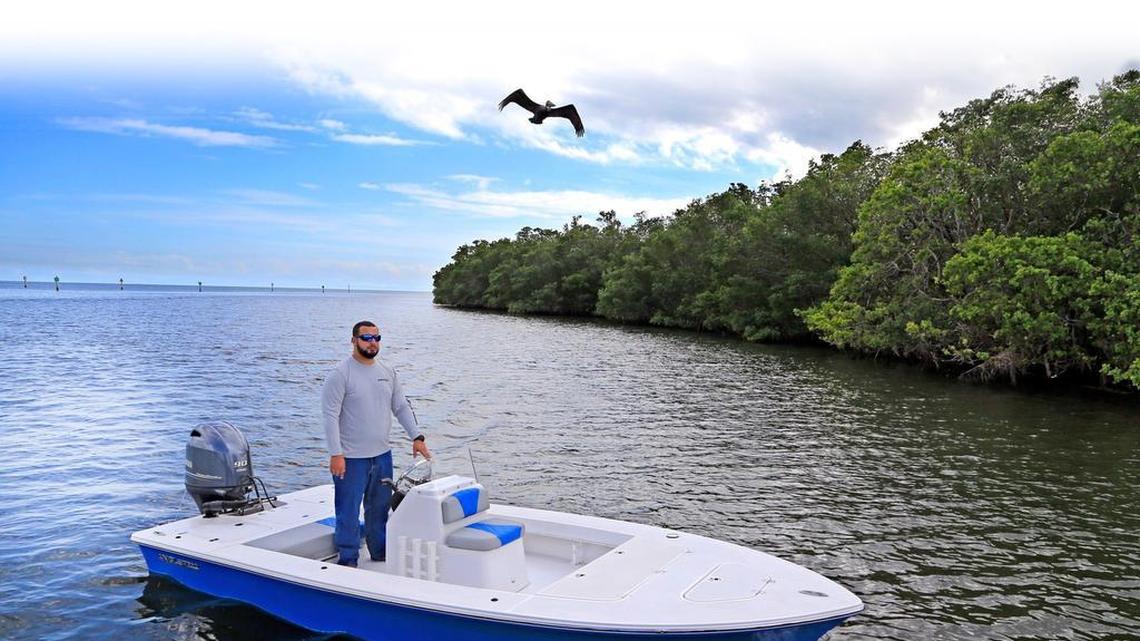Christopher Grillo, chief executive officer of Angler Pro Boats, with one of the company’s 17-foot flats skiffs at Matheson Hammock Marina.