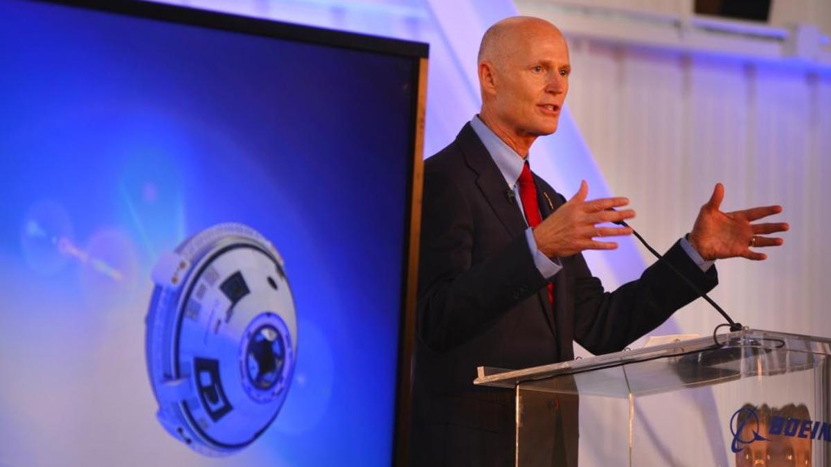 
Gov. Rick Scott speaks during the grand opening for Boeing’s Commercial Crew and Cargo Processing Facility (C3PF) at Kennedy Space Center, on Friday, Sept. 4, 2015. On the screen is a rendering of the CST-100 Starliner. The building was formerly a processing facility for the space shuttle. 
