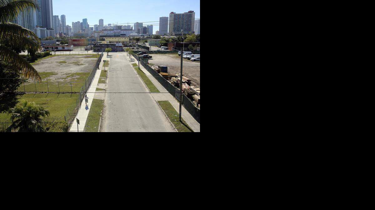 
A man runs past a vacant lot between Northeast 14th and 15th Streets, just west of Northeast First Avenue in Miami, on Friday, Jan. 30, 2015. 
