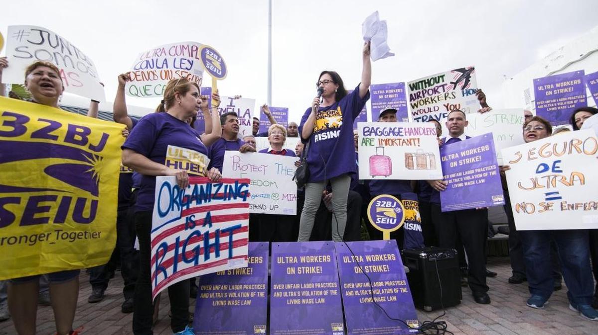 A group of workers lead by SEIU State Director Helene O’Brien during an airport strike against Ultra Aviation’s healthcare policy at Miami International Airport in Miami on June 29, 2017.