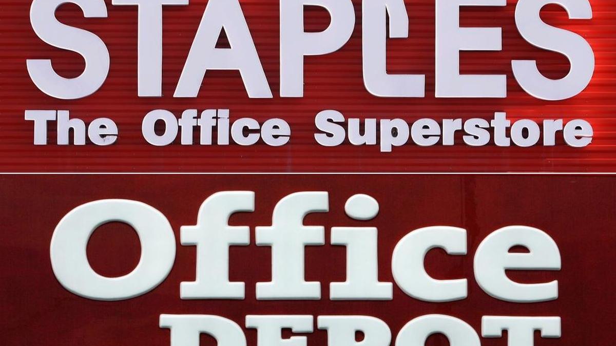 This combination made with 2009 file photos shows signage for a Staples store in Springfield, Ill., top, and an Office Depot store in Miami Springs.