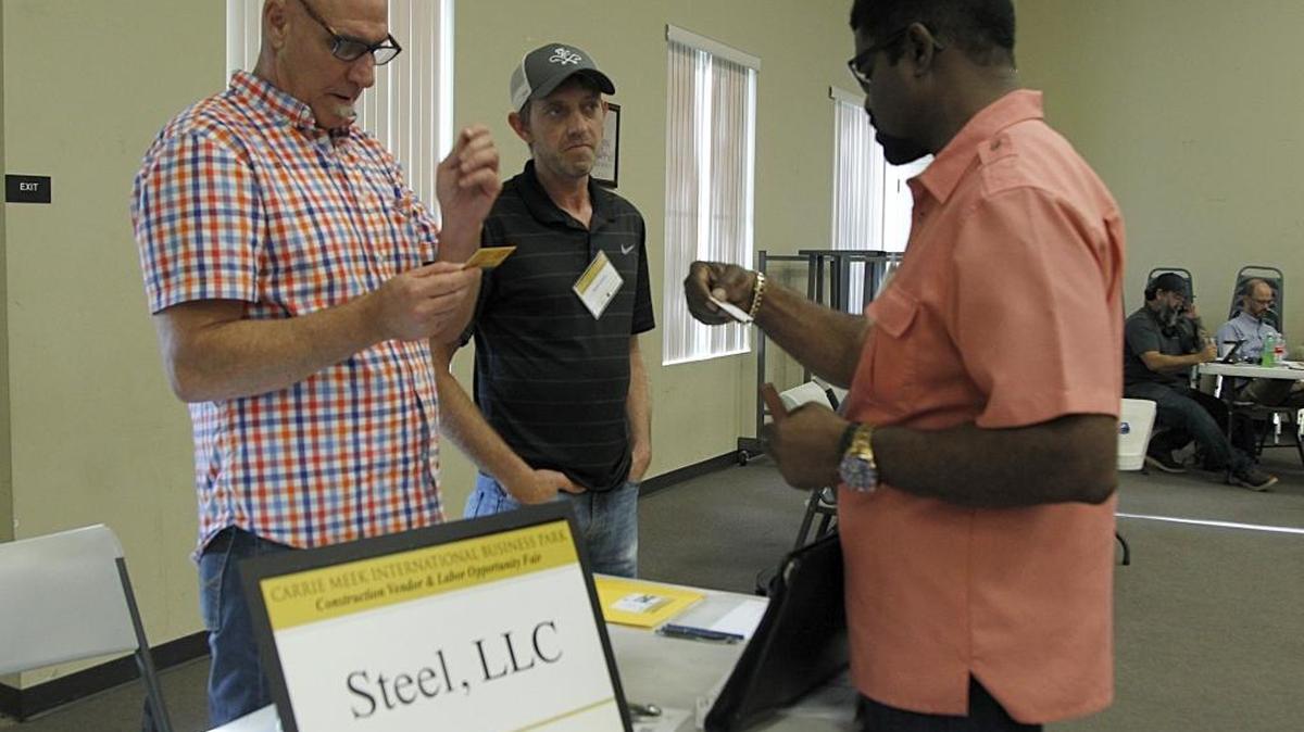 From left, Dana Wells, with Steel LLC, and James Gravett, with A&D Welding Inc., talk to Roosevelt Bradley during the Construction Vendors and labor opportunity job fair for the new Carrie Meek International Business Park on Oct. 16, 2017.