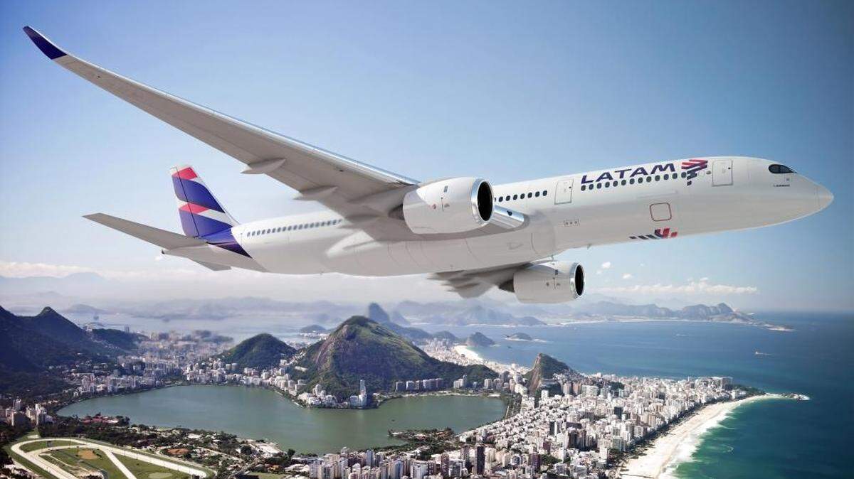 FILE - A plane sporting the new LATAM livery flies over Rio de Janeiro. The airline added flights to handle the influx of travelers to the 2016 Rio Olympics.