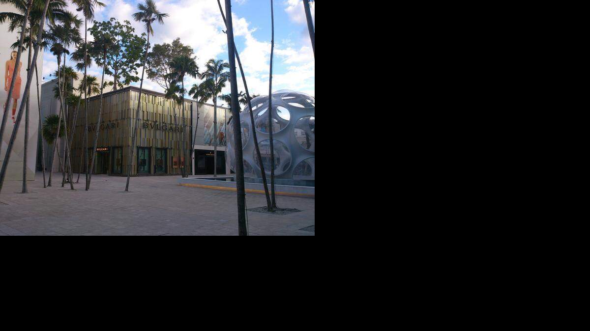 
 A plaza in the heart of Miami’s Design District, with its growing stable of luxury retailers, features outdoor artwork and palm trees. 
