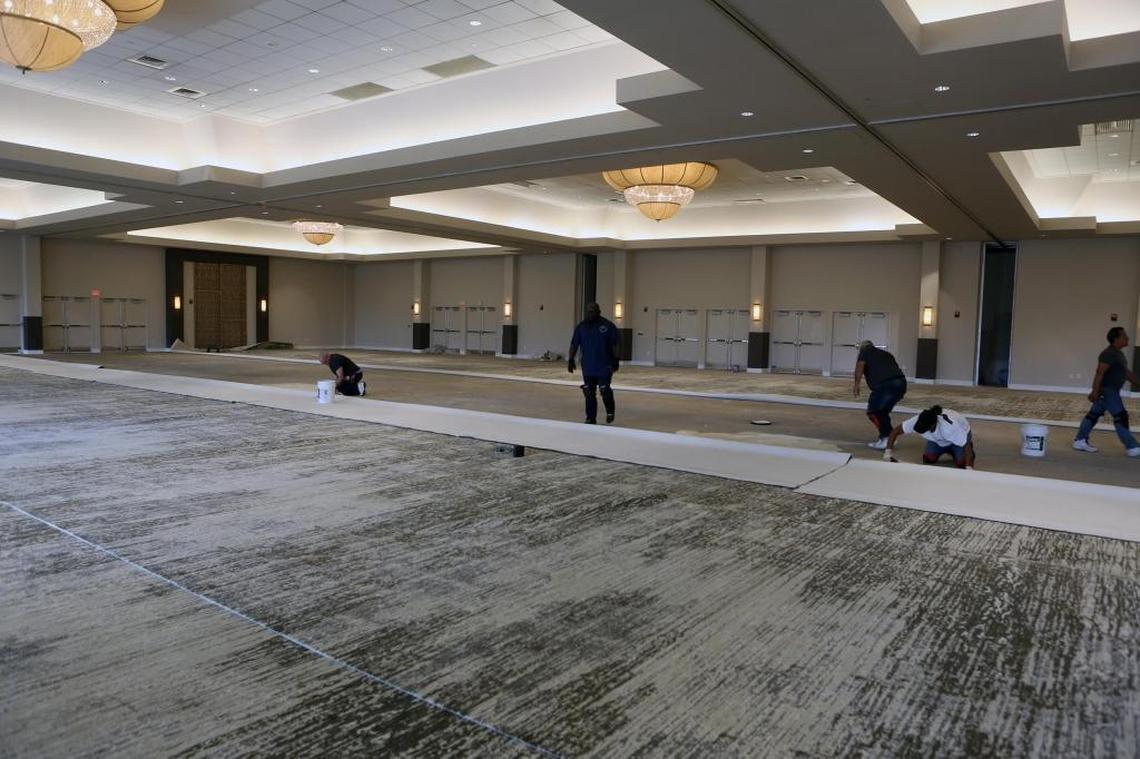 Workers lay carpet in one of the renovated ballrooms at Jungle Island on Wednesday, Feb. 7, 2018. The park’s meeting spaces will reopen Tuesday.