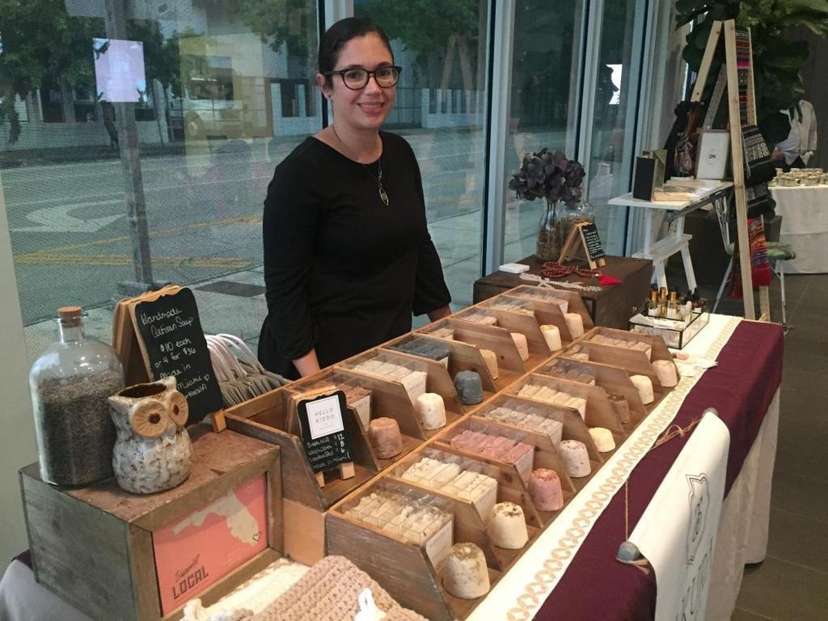 Jaclyn Rosell jumped from jobs with benefits to the Gig Economy to work at home and spend more time with her 3-year-old daughter. “Some afternoons I just want to sit with her and watch five episodes of My Little Pony with her – you can’t put a price on that,” she said. She creates and sells hand-made soap through her one-woman company, Sakura Soap. She is pictured at a pop-up booth displaying her products.