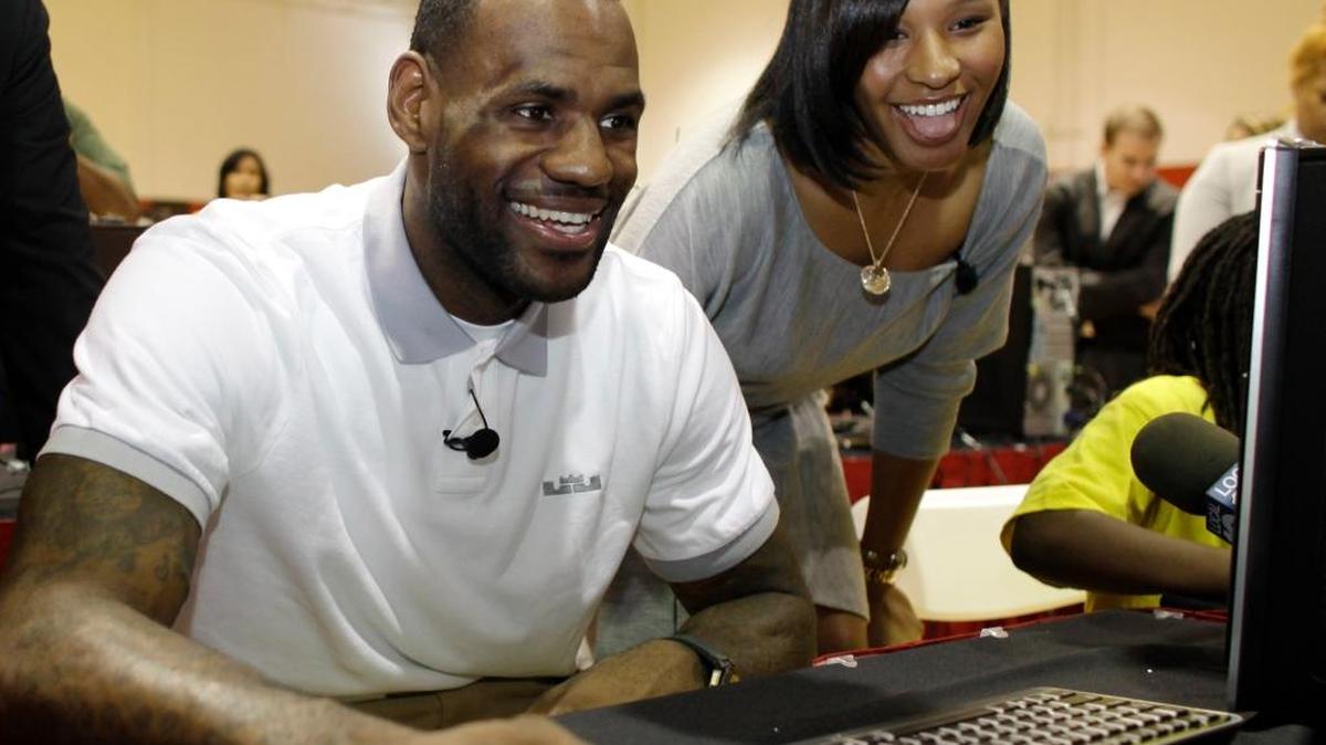 In a March 2, 2011 file photo, LeBron James sits with his girlfriend, Savannah Brinson, at a new computer during a charity event at the Northwest Boys & Girls Club in Miami. James and Brinson married in 2013.