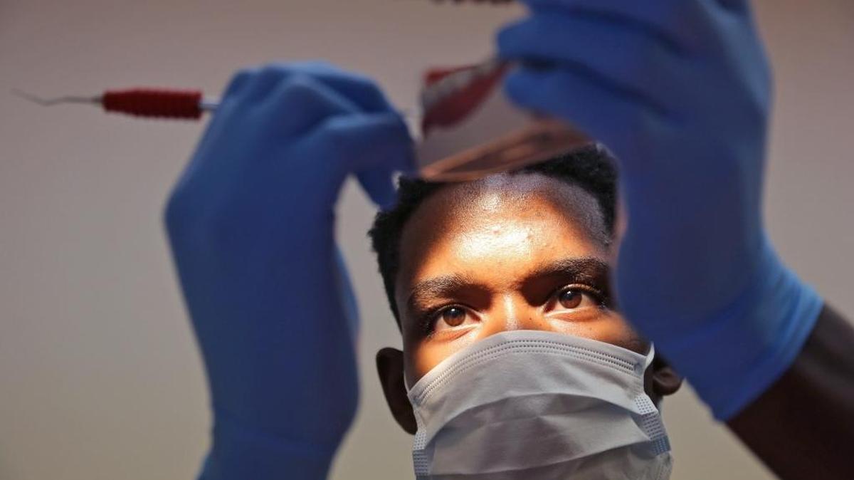 Jefferson Germain, a North Miami High School senior and aspiring dentist, practices cleaning teeth while interning at Dr. Elena Katz’s dental office. Germain is one of 1400 teens participating in Miami-Dade County’s summer internship.