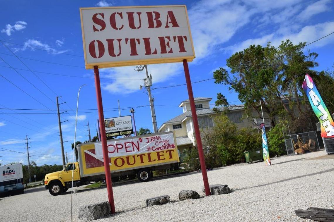 A sign at the Scuba Outlet in Key Largo invites travlers back to the region. Key Largo and Key West were largely spared by Hurricane Irma.