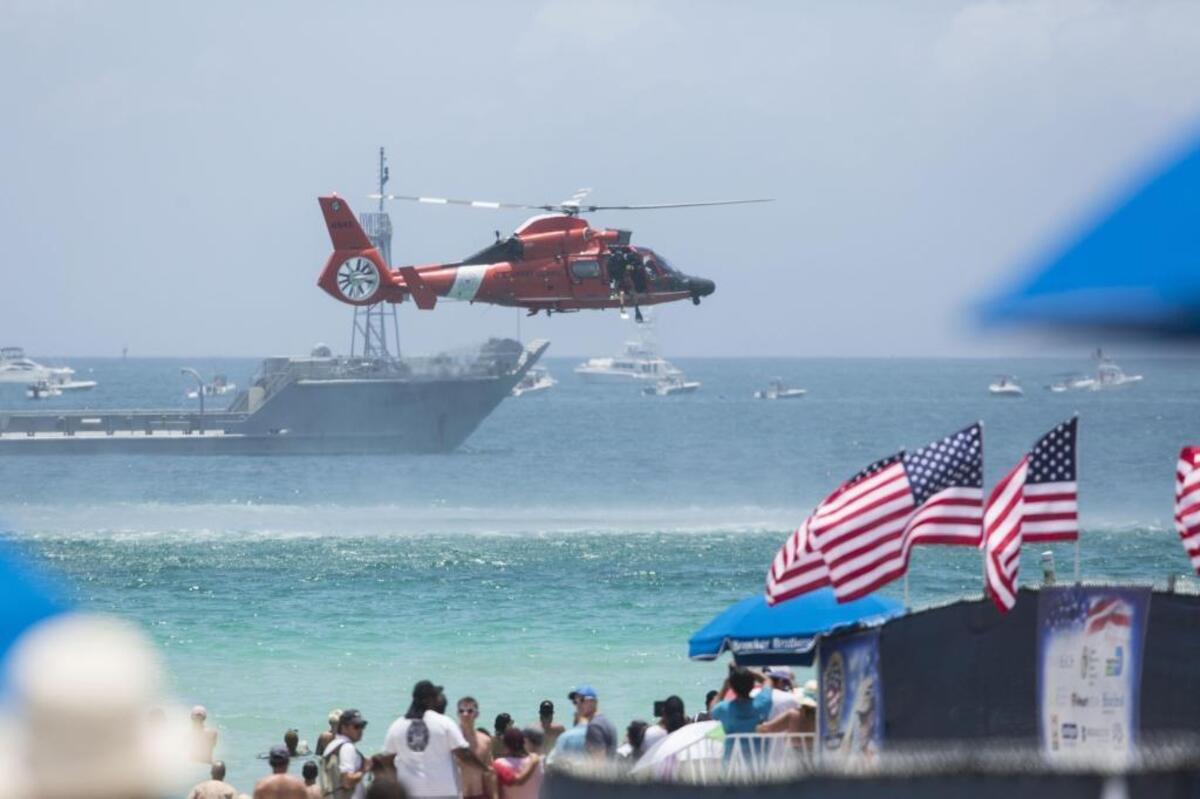 U.S. Coast Guard HH-65 Dolphin does a demonstration of an ocean rescue. The simulation is part of the Memorial Day Air and Sea Show on Miami Beach on Saturday, May 27, 2017.