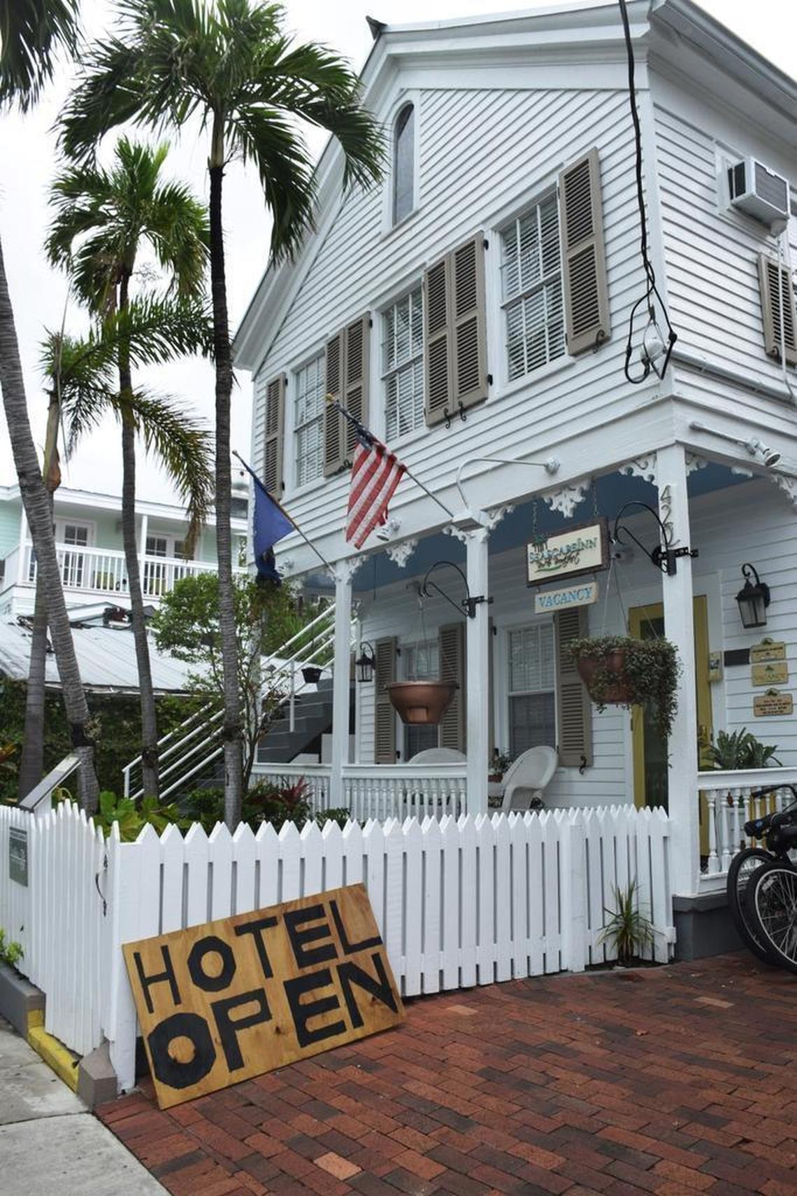 A hotel near the Ernest Hemingway Home in Key West displays a plywood sign on Oct. 5 indicating the property is open.