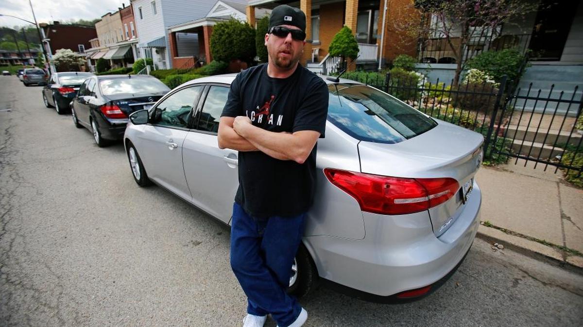 In this Tuesday, April 26, 2016, photo, Louis Cervi stands by his leased Ford Focus in front of his Pittsburgh home. Cervi had been looking to buy a small car for basic transportation, with a reasonable monthly payment. With many Americans rushing to buy trucks and SUVs, there are good deals to be had on cars, especially smaller models.