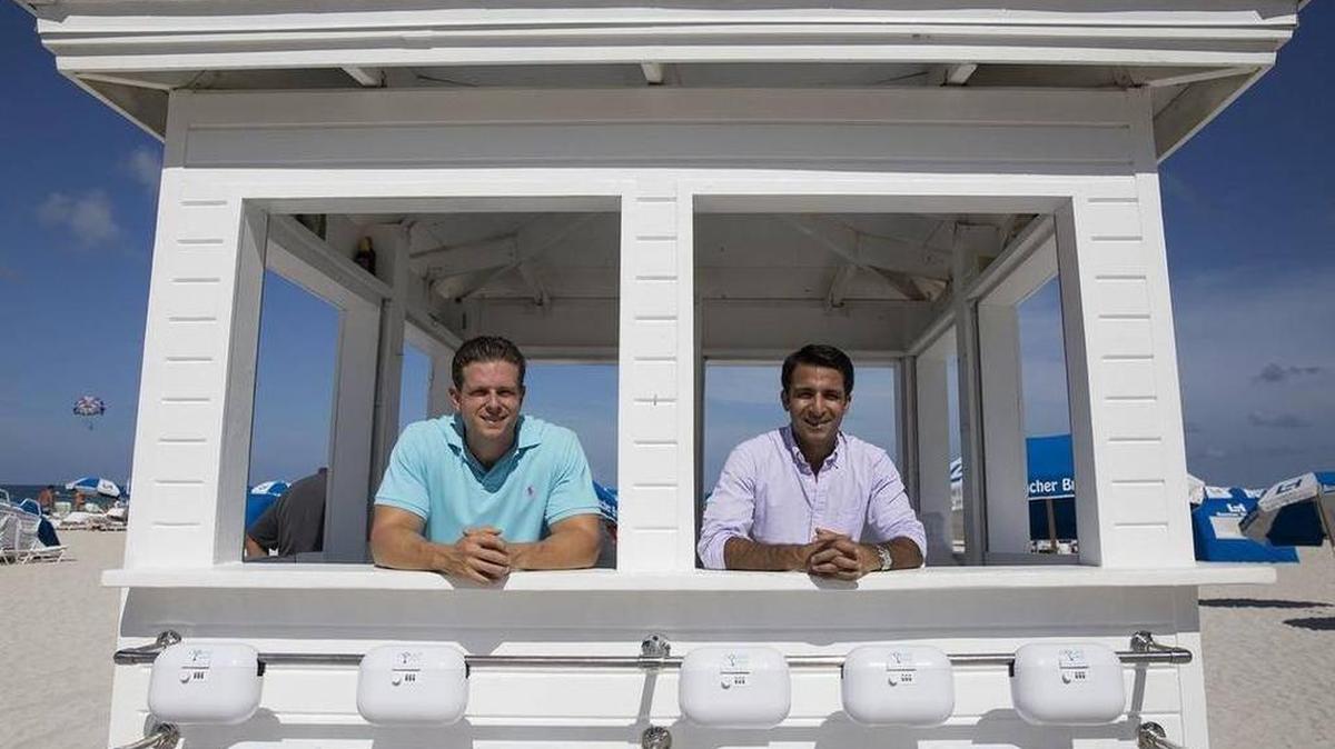 Entrepreneurs Jonathan Kinas and Avin Samtani pose with their product AquaVault at the Loews Miami Beach. AquaVault is a small portable safe for securing money and other personal items at the beach.
