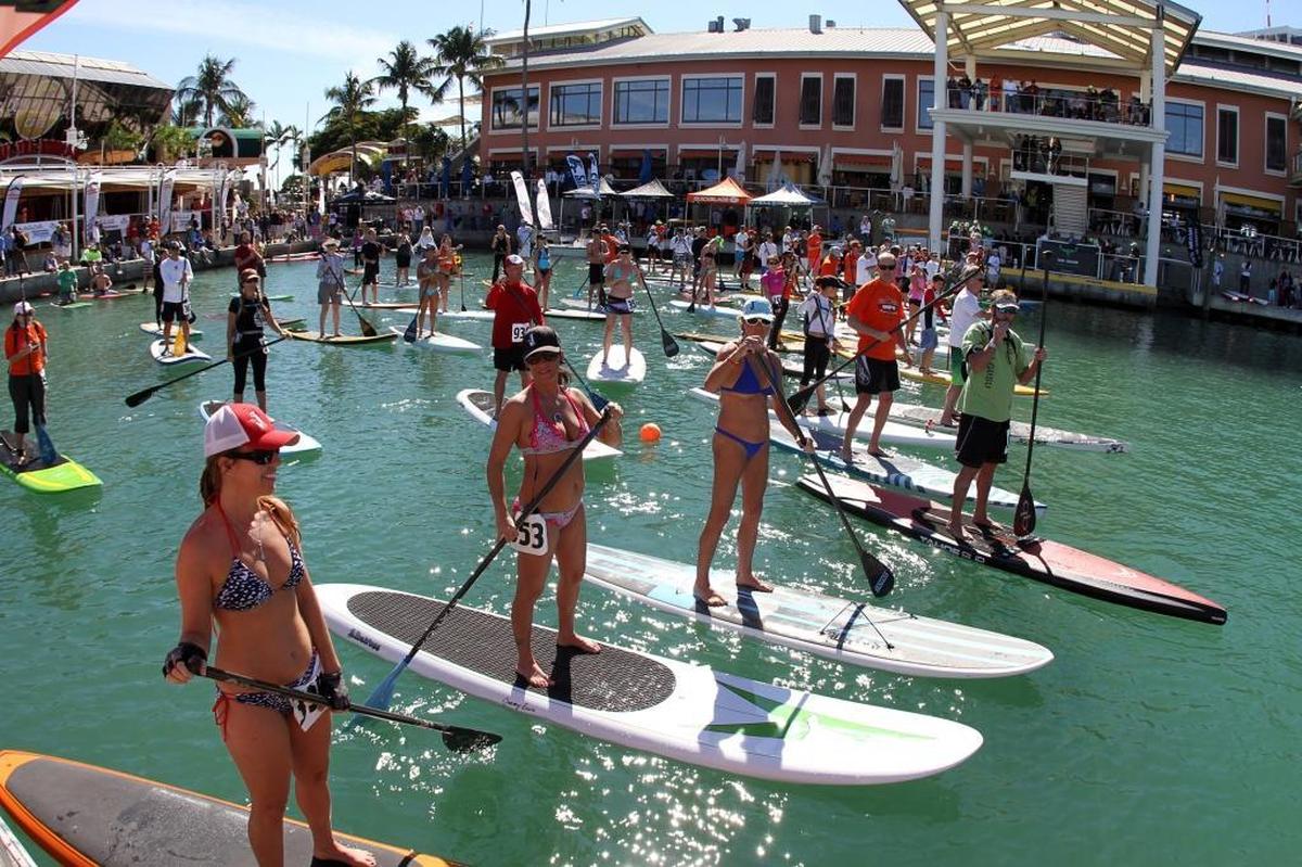 Paddle boarders gather around the starting line of the three mile recreational race during the Orange Bowl Paddle Championship at Bayside Marketplace on Sunday, Jan. 15, 2012. The paddle boarding event brought out advanced, recreational and beginner paddlers, and even a few dogs, to the waters of Biscayne Bay.