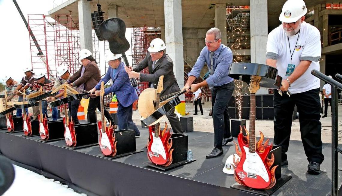Dignitaries smash guitars on the site of the new guitar-shaped hotel at an event to preview the new hotel at the Seminole Hard Rock Hotel & Casino in Hollywood, Florida, on Oct. 25.