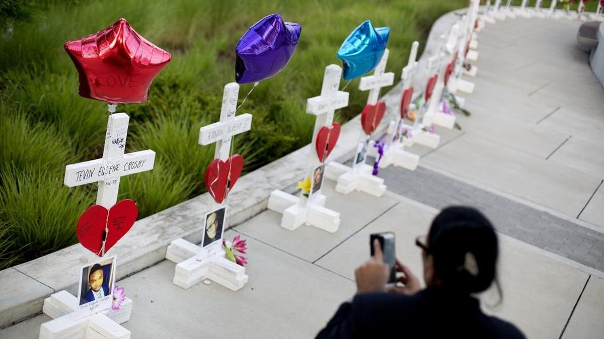 Crosses, one for each victim, line a walkway as a memorial to those killed in the Pulse nightclub mass shooting a few blocks from the club early Friday, June 17, 2016, in Orlando.