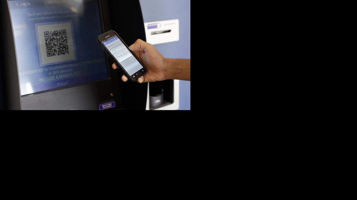 
In this 2014 photo, a customer uses a bitcoin ATM machine in Austin, Texas.
