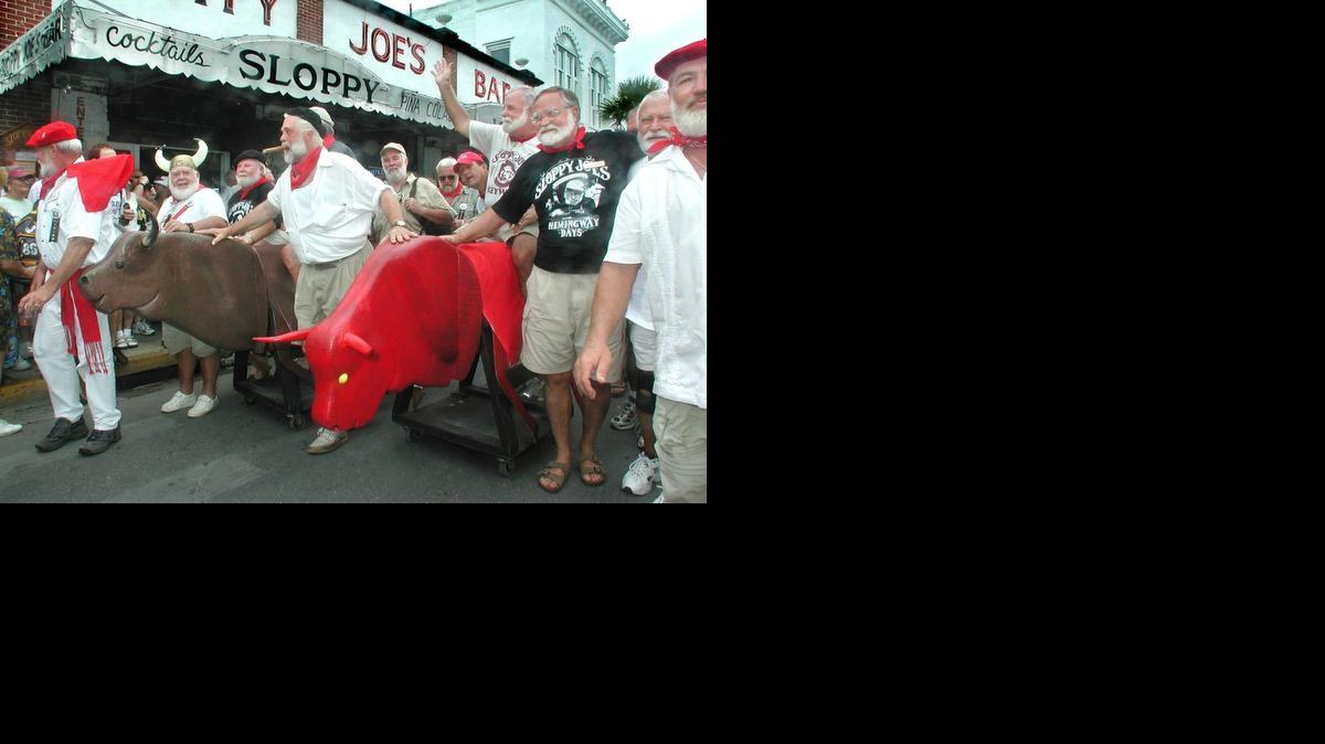 
Ernest Hemingway Look-a-likes parade down Duval Street during Key West's version of the "Running of the Bulls" at the 2001 Hemingway Days Festival. The Keys tourism bureau plans to use Hemingway to promote Key West as a destination for Cuba vacations once the United States lifts tourism restrictions on the island. 
