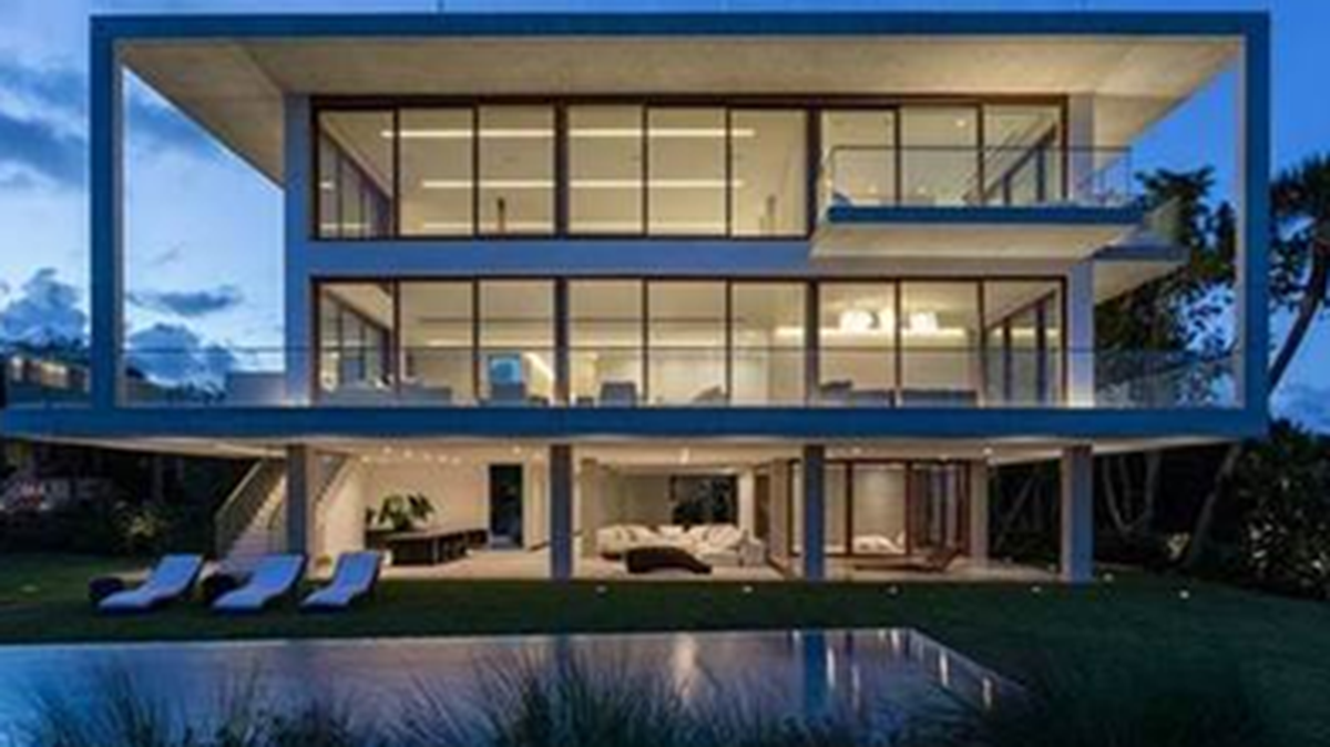 The 20,000-square-foot Casa Bahia, designed by Alejandro Landes, features a minimalist style and an exposed exoskeleton wrapped in teak, glass and white stucco. The Coconut Grove home is on the market for $50 million.