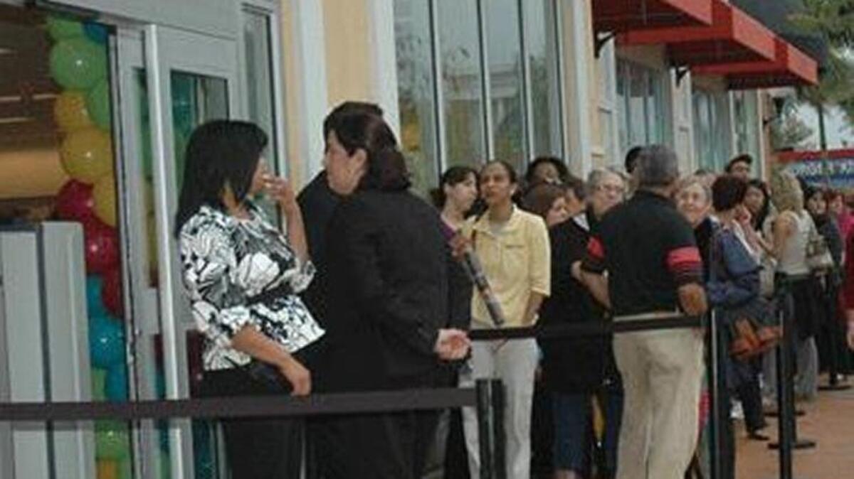 
Customers wait in a long line for the opening of Nordstrom Rack at The Palms at Town & Country in Kendall in 2010.
