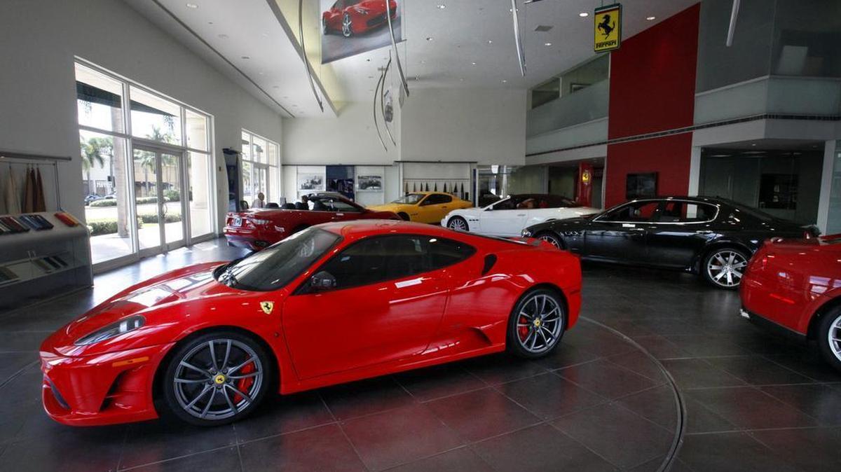 A Ferrari F430 Scuderia Coupe shares a showroom with Maseratis, part of the inventory at The Collection, a luxury car dealership at 200 Bird Rd., Coral Gables.