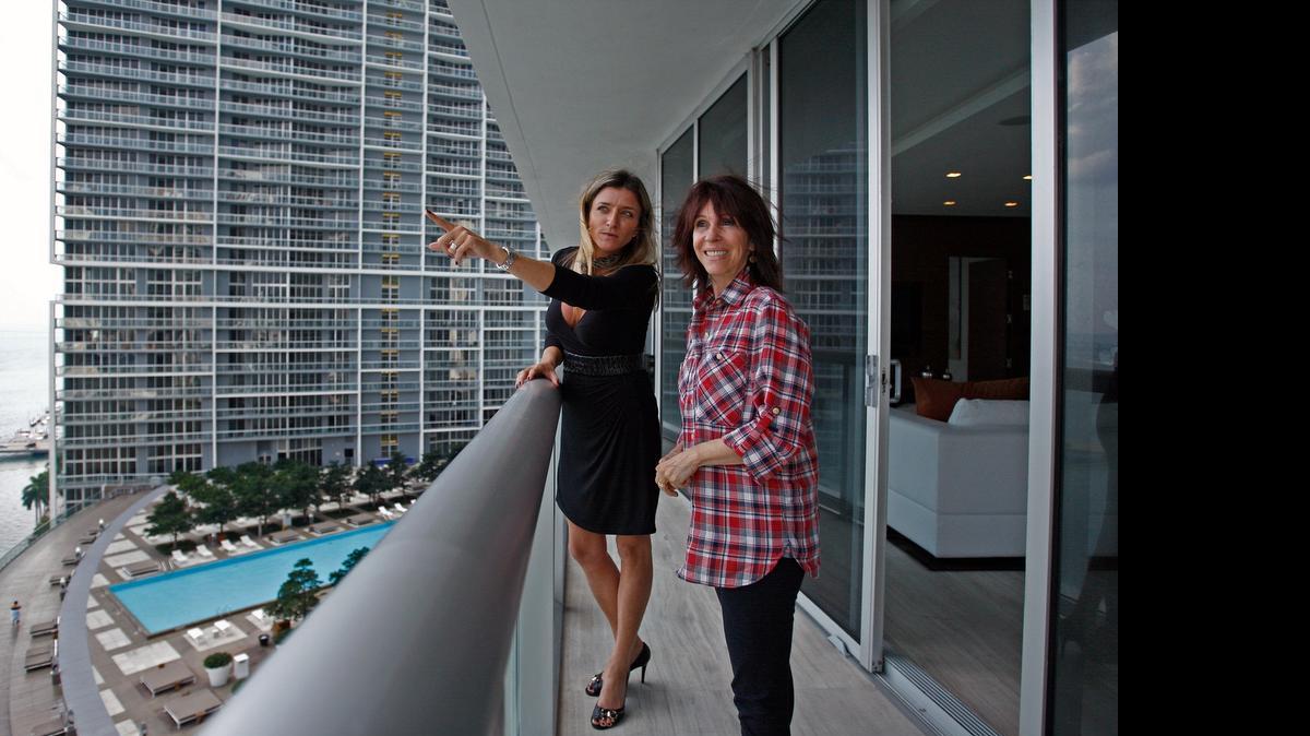 
Real estate agent Fabiana Pimenta shows the Artefacto model apartment to Maria Helana Abreu of Brazil in 2011. Brazilians have been among the top investors in South Florida’s luxury condo market since the financial crisis ended.
