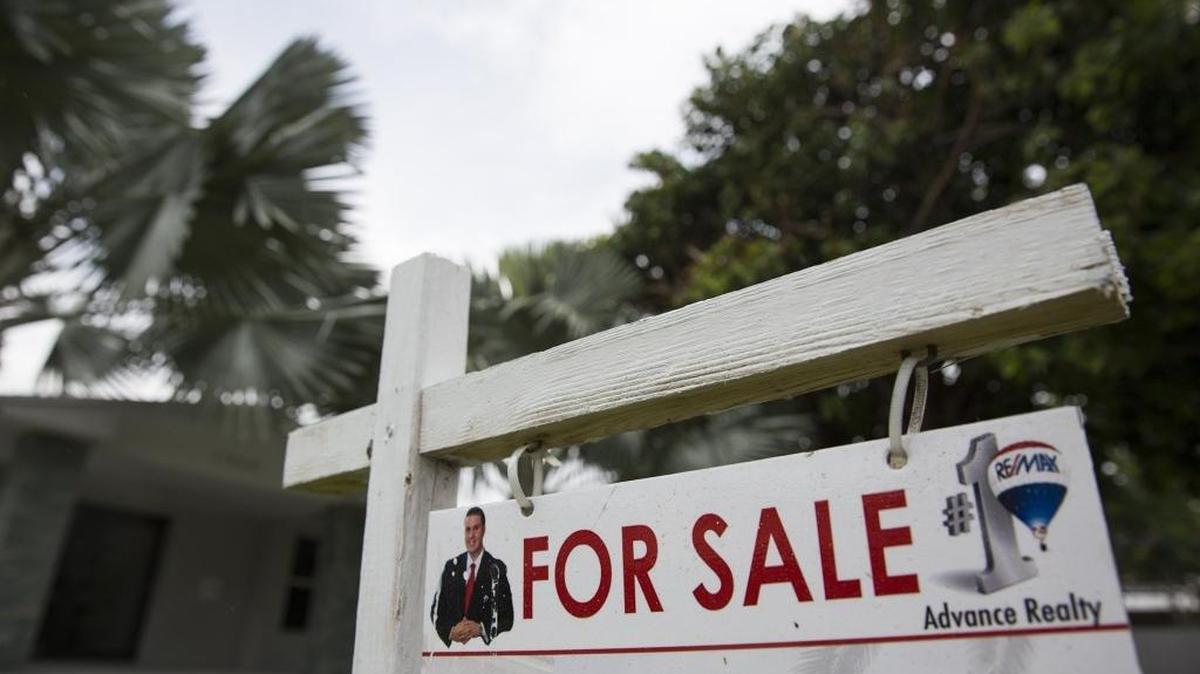 A sign posted outside a home for sale on Southwest 73rd Avenue in Pinecrest on Wednesday, June 10, 2015.