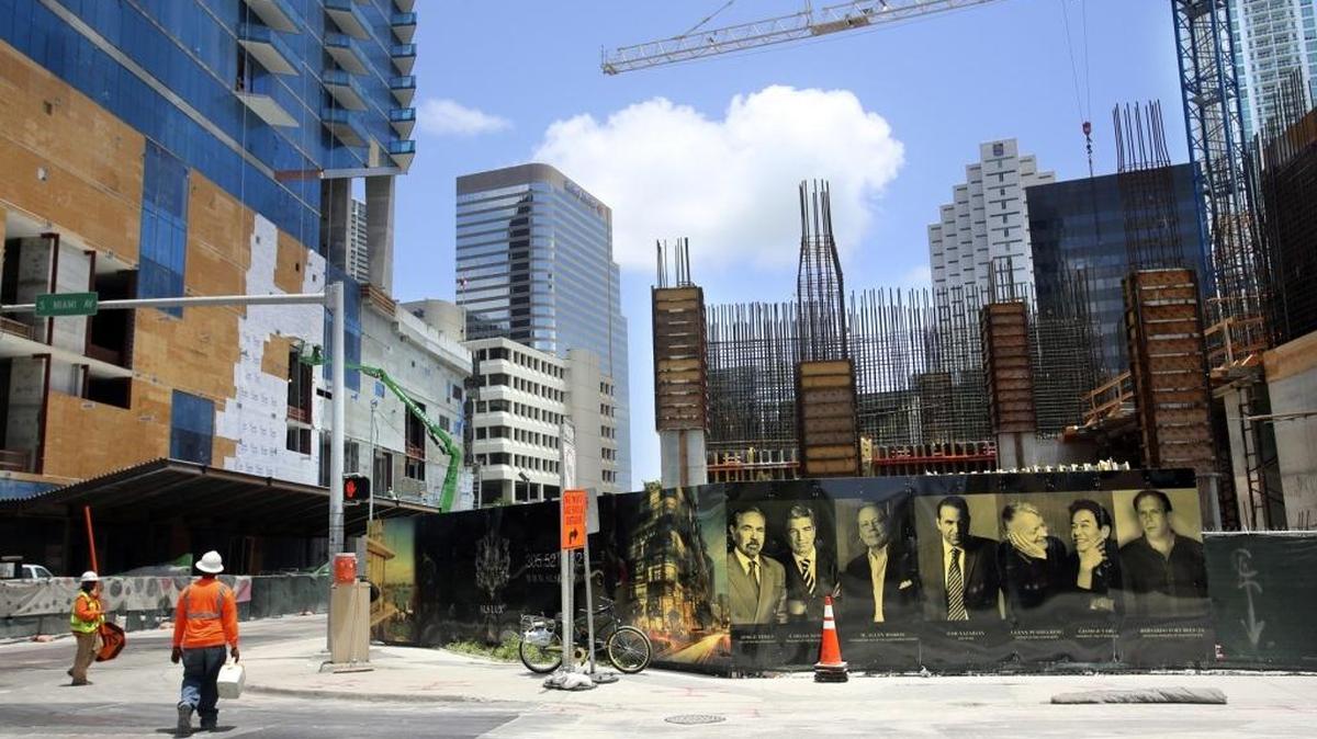 
A construction crane towers above the SLS Lux Brickell, a 57-story condo going up in Miami's Brickell district, on Thursday, Aug. 6, 2015. 
