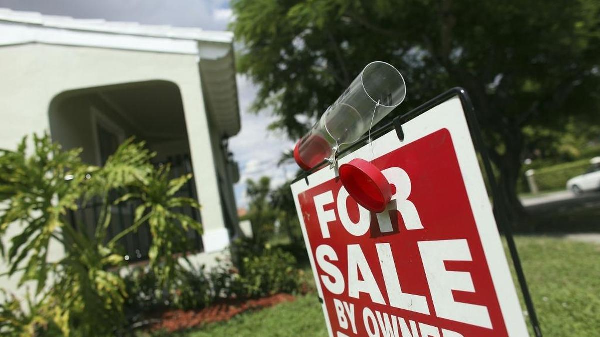 A for sale sign is displayed outside a home in Miami.