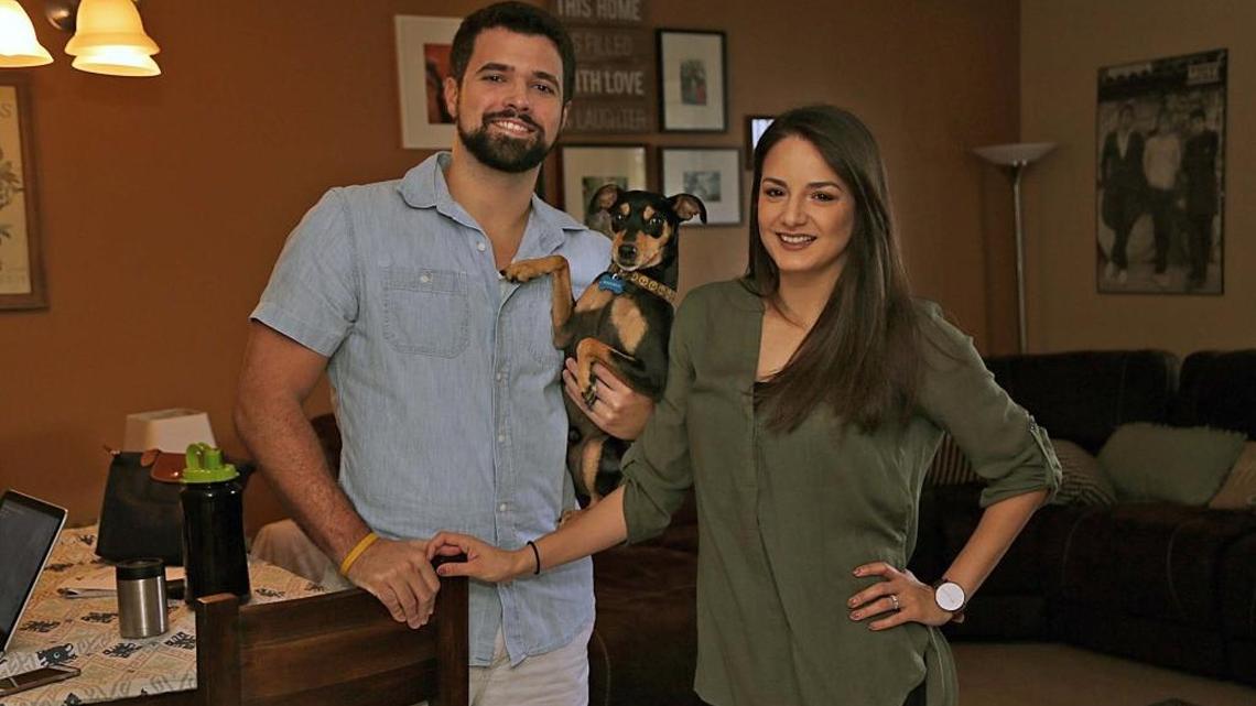 Jason Lopez and his wife Yadira Lopez pose with their dog Maverick in the apartment they rent in Kendall. Both work good jobs but market forces have priced them out of buying a home in Miami-Dade County.