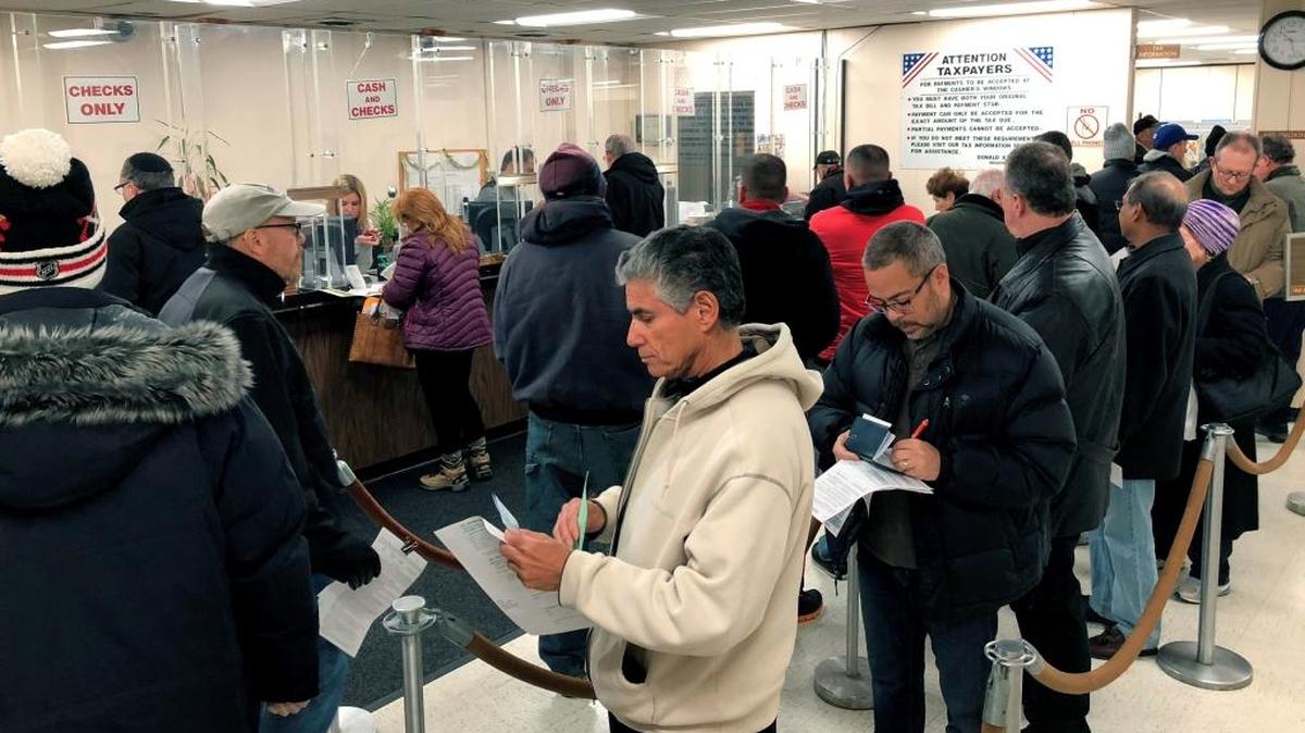People line up at the Town of Hempstead tax receiver’s office in New York on Dec. 26 to pay their real estate taxes before the end of the year, hoping for one last chance to take advantage of a major tax deduction before it is wiped out in the new year. In Florida, taxpayers can’t pre-pay their 2018 property taxes.
