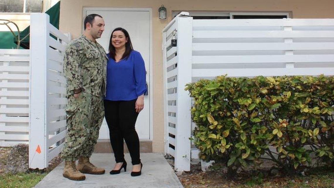 Erika Rivera and husband Luis Rivera, a Navy petty officer first class, pose in front of their new home in West Kendall.