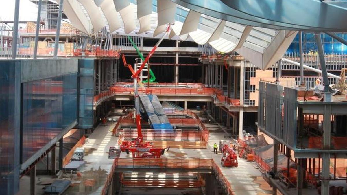 A file photo from June shows construction at Brickell City Centre’s shopping center, including at top a $30 million “climate ribbon” designed to keep the open-air space cool.