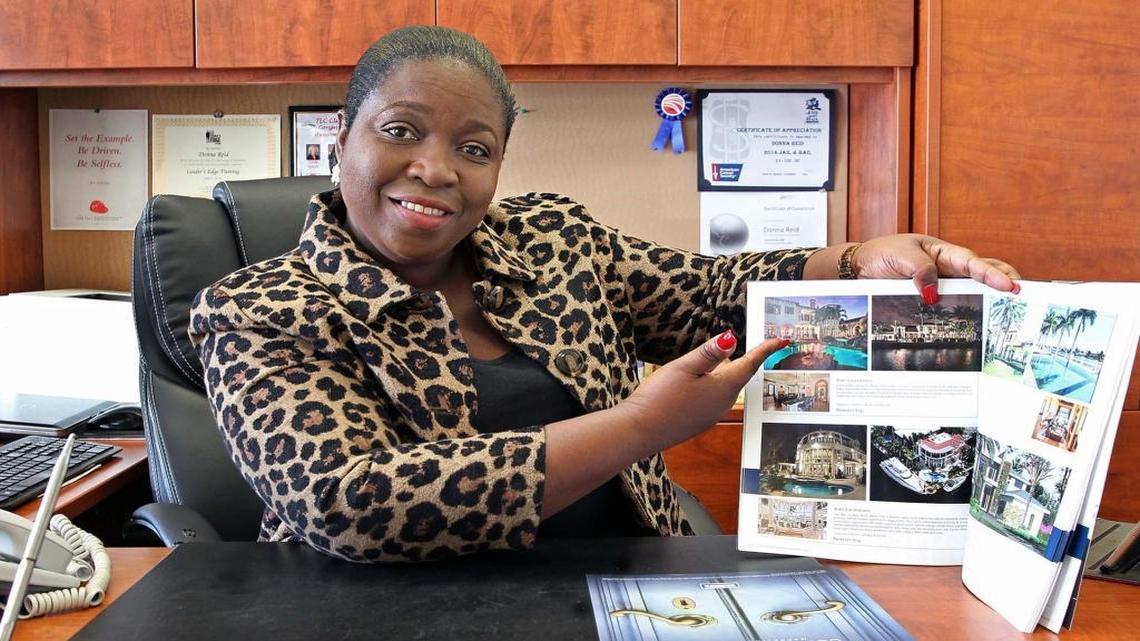 Donna Reid, branch manager for Coldwell Banker Residential Real Estate, shows images of homes available from her office in Hollywood on Thursday, February 2, 2017.