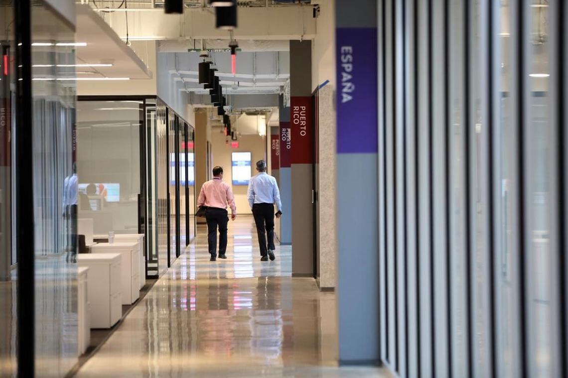 Different areas of the brand new Telemundo Center are separated into ‘neighborhoods’ with names of countries in their viewing audience areas. Two employees walk past the Puerto Rico ‘neighborhood’ on the third floor of the new HQ building. The Spanish-language TV giant is inaugurating its new state-of-the-art, $250 million HQ building on Monday, April 9, 2018, that will bring all of the company’s various arms — corporate, news department, creative — under one giant roof.