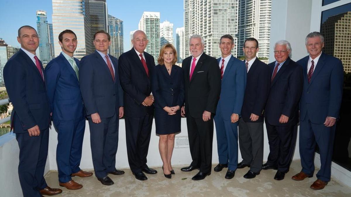 A photo shows Cresa South Florida and JLL management. L-R: John Marshall, Matthew Cheezem, Alan Kleber, Charlie Barton, Barbara Liberatore Black, David Prevé, Matthew Goodman, Doug Irmscher (JLL), Don Cartwright (JLL), and Glenn Olson.