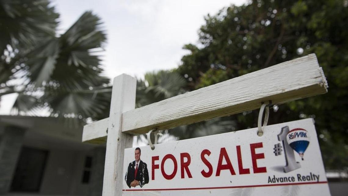 A sign posted outside a home for sale in Pinecrest on Wednesday, June 10, 2015.