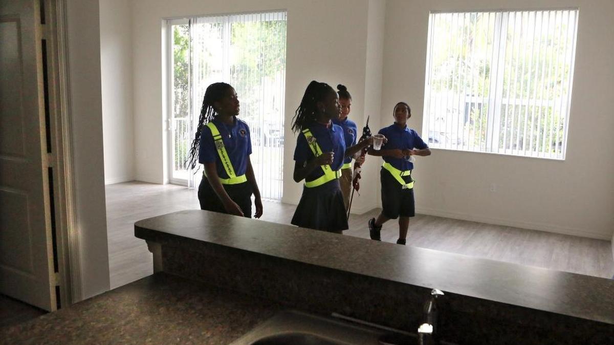 Students from Gibson Charter School tour a two-bedroom apartment at Courtside Apartments, after they led the Pledge of Allegiance during the grand opening ceremony for the new affordable housing complex in Miami's historic Overtown community. The grand opening was Friday, Sept. 23, 2016, at 1699 NW Fourth Ave. The project is the result of a joint venture between Housing Trust Group, one of the largest developers of affordable housing in Florida, and NBA legend Alonzo Mourning, director of AM Affordable Housing, Inc. The 84-unit building has one-, two- and three-bedroom apartments, already leased, and a long waiting list, due to the shortage of affordable housing.