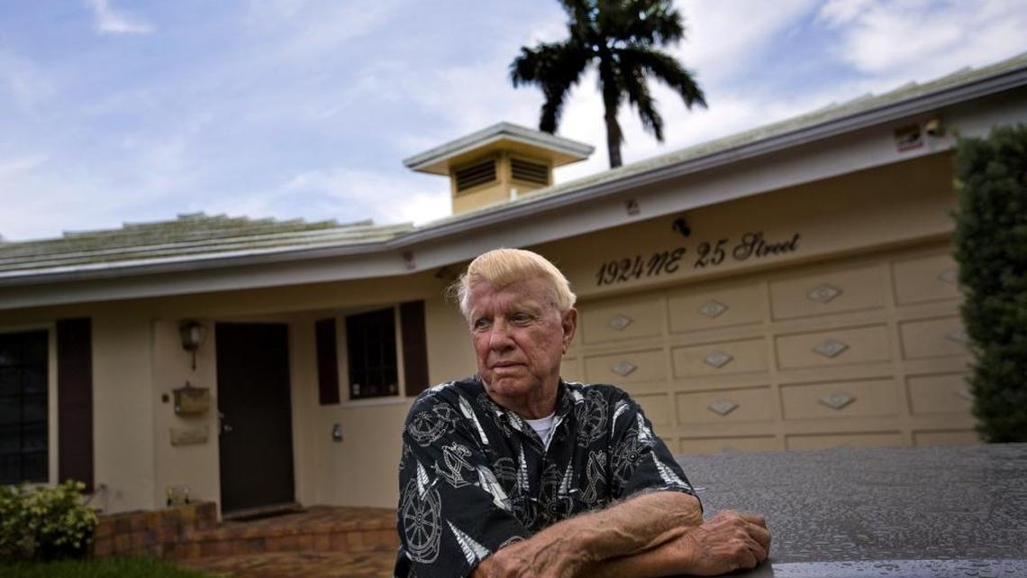 Kenneth Tuch stands outside the home in Wilton Manors where he’s lived for 42 years. A bank now owns the home. Tuch said he was scammed by a convicted Ponzi schemer, who took out a fraudulent mortgage. But a court said he has to move out by Jan. 6th.