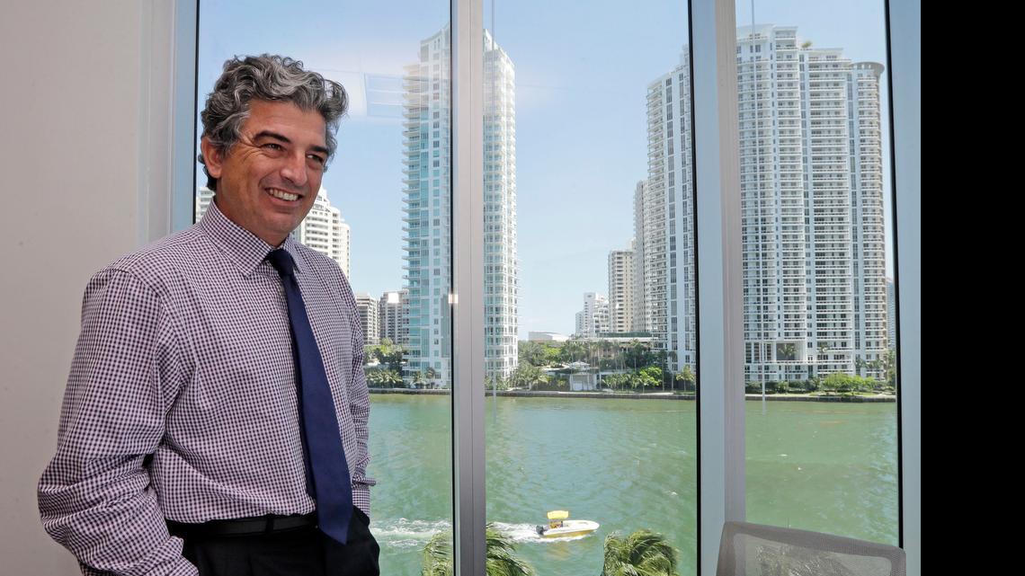 
In this Wednesday, May 20, 2015 photo, Carlos Rosso, president of the condominium division at The Related Group, smiles as he talks to a reporter at his office in downtown Miami. In the 10 years since Florida was hit by eight hurricanes, the construction of high-price condominiums and other structures along its coasts has escalated as the decade passed and the storms faded from memory. Rosso is shown in the Related Group’s corporate office at 315 S. Biscayne Blvd.
