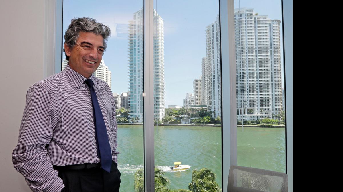 
In this Wednesday, May 20, 2015 photo, Carlos Rosso, president of the condominium division at The Related Group, smiles as he talks to a reporter at his office in downtown Miami. In the 10 years since Florida was hit by eight hurricanes, the construction of high-price condominiums and other structures along its coasts has escalated as the decade passed and the storms faded from memory. Rosso is shown in the Related Group’s corporate office at 315 S. Biscayne Blvd.
