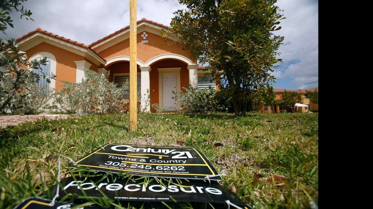 
A “for sale” sign lays on the ground in front of a foreclosed home in Homestead in 2009.
