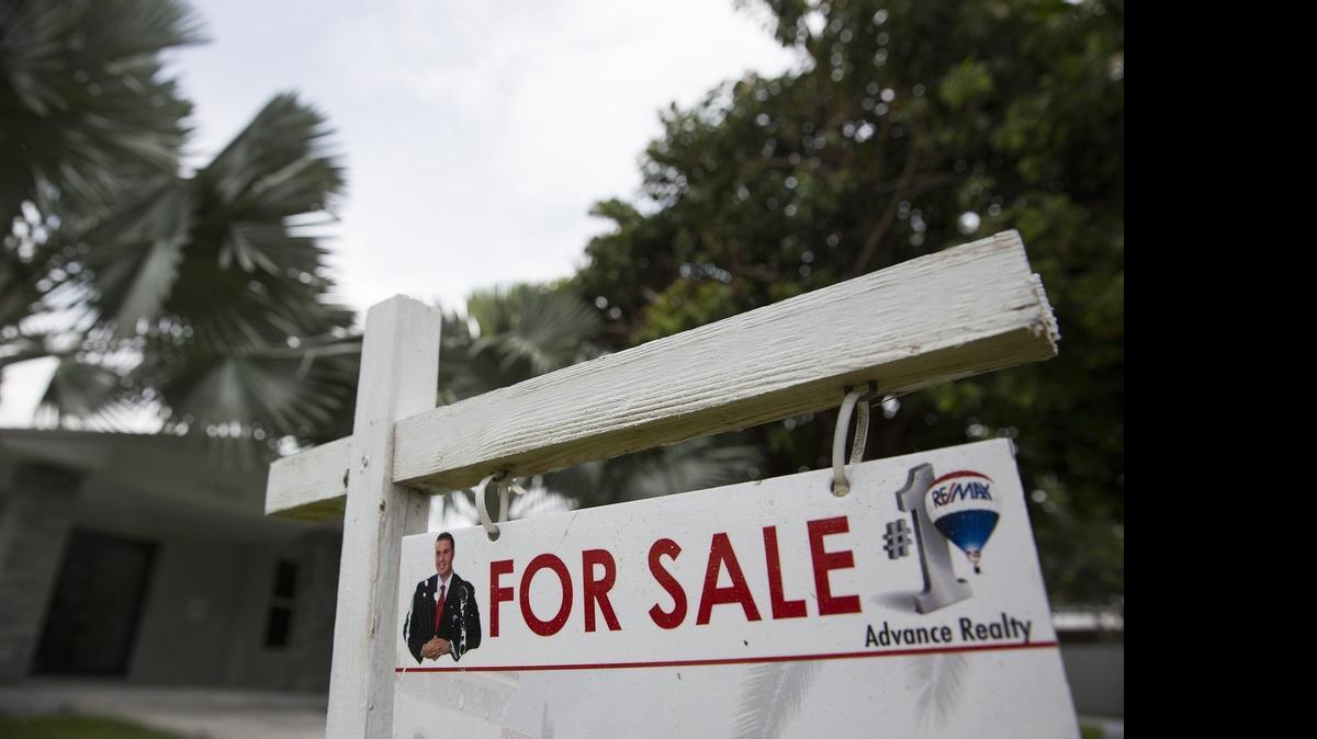 
A sign posted outside a home for sale on Southwest 73rd Avenue in Pinecrest on Wednesday, June 10, 2015.

