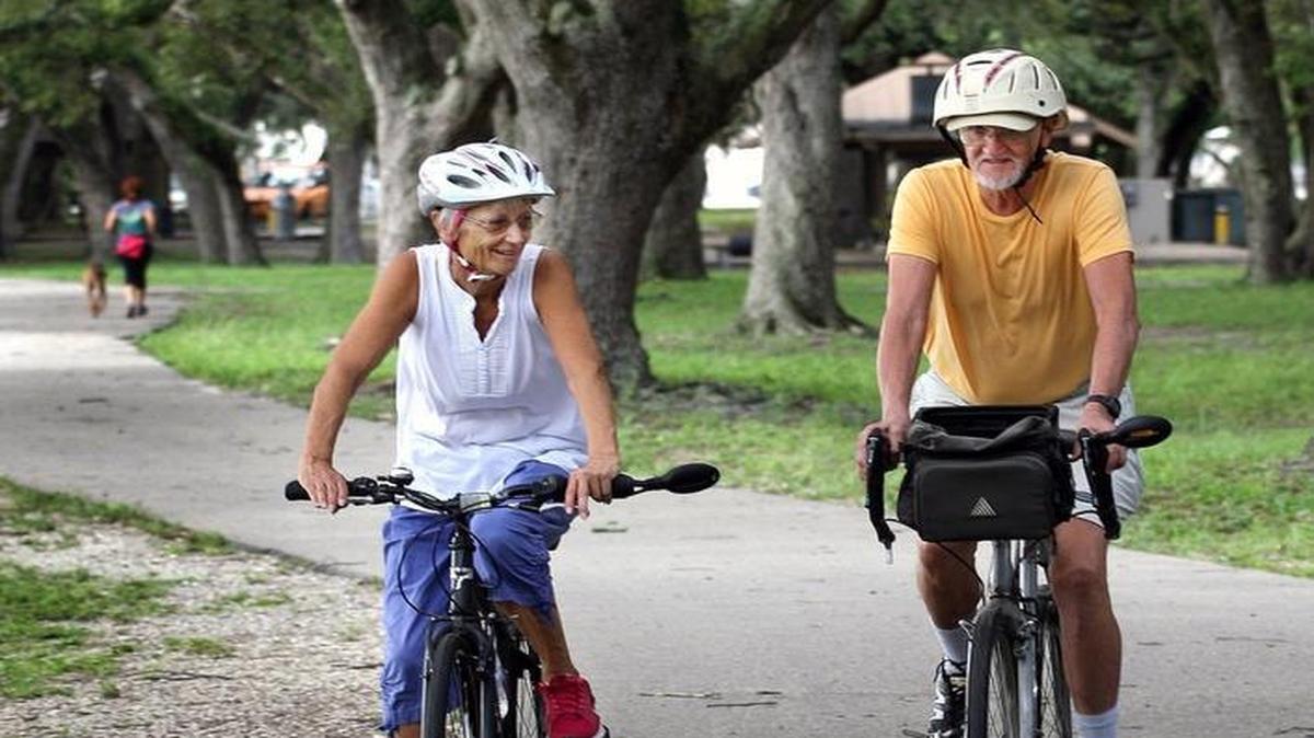 Retirees cycling on a bike path.