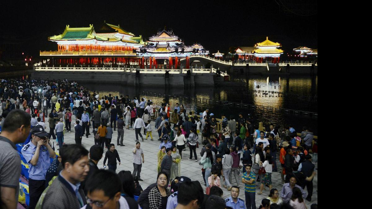 
In this photo taken May 9, 2015. visitors leave after a multimedia show at the New Yuanmingyuan, a newly-built replica of Beijing's Old Summer Palace which was looted and destroyed by French and British forces in 1860, in Hengdian township of Dongyang city in east China's Zhejiang province. Hengdian Studios built the 30 billion yuan ($5 billion) film set of what it says the 3.5 square kilometer (1.35 sq. mile) palace grounds in Beijing looked like before they were razed and left in ruins by foreign forces more than 150 years ago.
