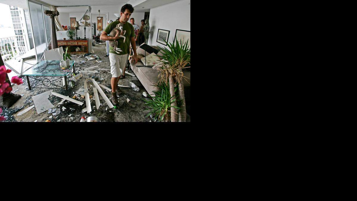 
Daniel Sanchez surveys the damage to his condo unit at Grandview Palace on North Bay Village after Hurricane Wilma in October 2005.
