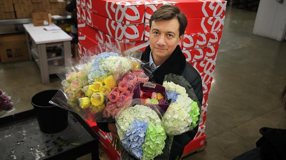 Juan Palacio, CEO and founder of BloomsyBox, displays a bouquet that is being prepared for shipping at his company warehouse in Miami Springs.