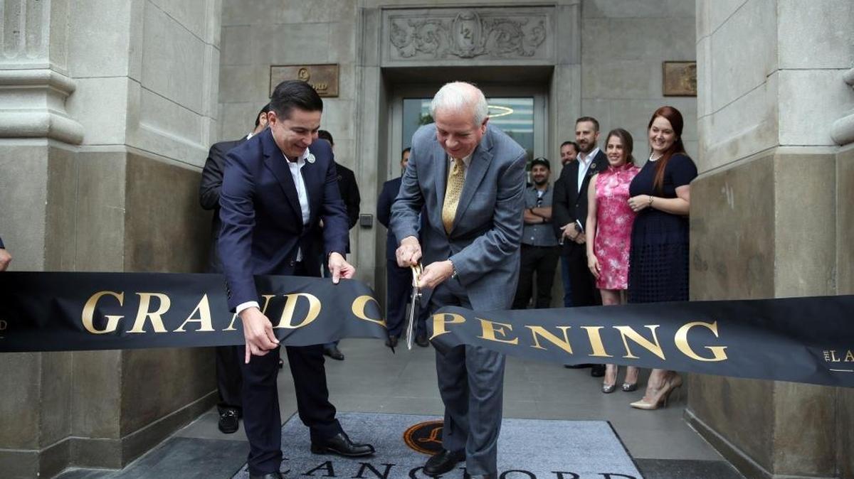 The Langford Hotel in downtown Miami, opened with a ribbon cutting by Miami Mayor Tomás Regalado, (right). Regalado said the hotel will reenergize the urban core of Miami.