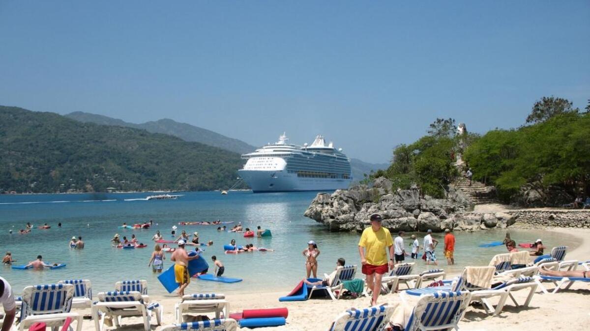 FILE--Passengers on Royal Caribbean International's Mariner of the Seas relax on May 23, 2006, on a beach at Labadie, Haiti. Royal Caribbean’s 3,634-passenger Freedom of the Seas canceled its scheduled visit Tuesday at the Haitian port of Labadee after the ship encountered a number of locals in small boats staging a protest, according to a company release.